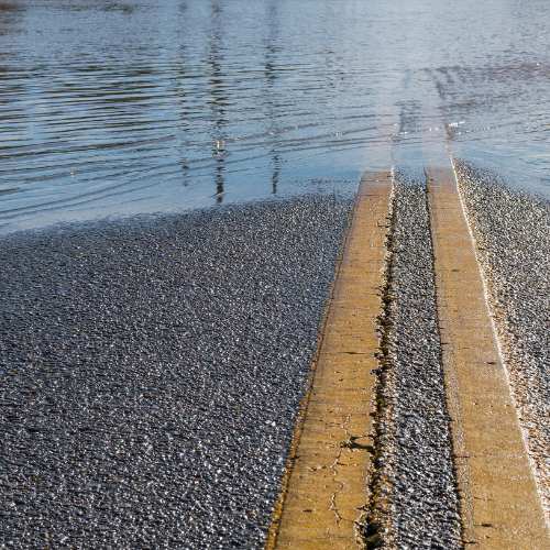 Picture of road with yellow centre line and flooding